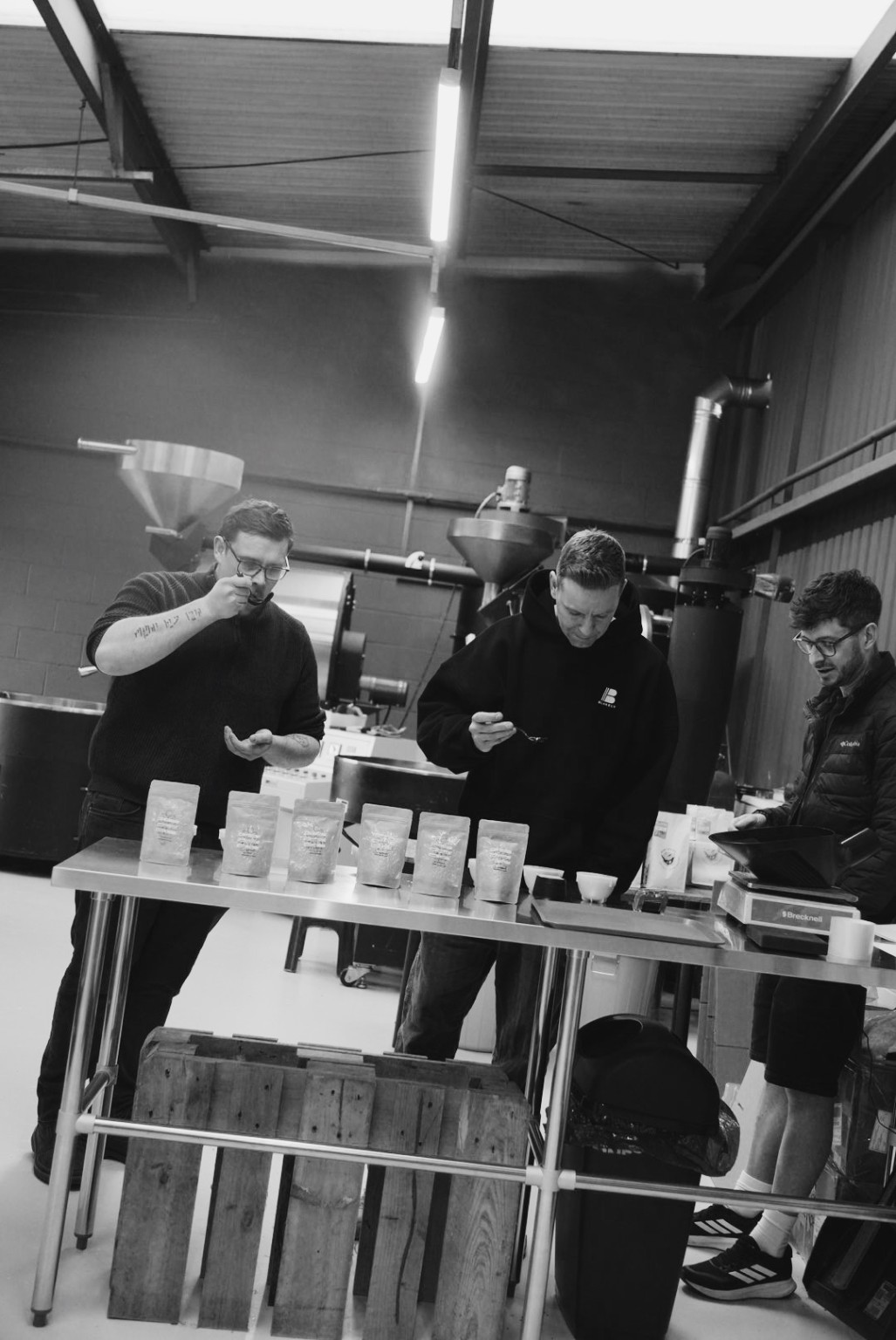 Three people tasting coffee together at the Northside roastery